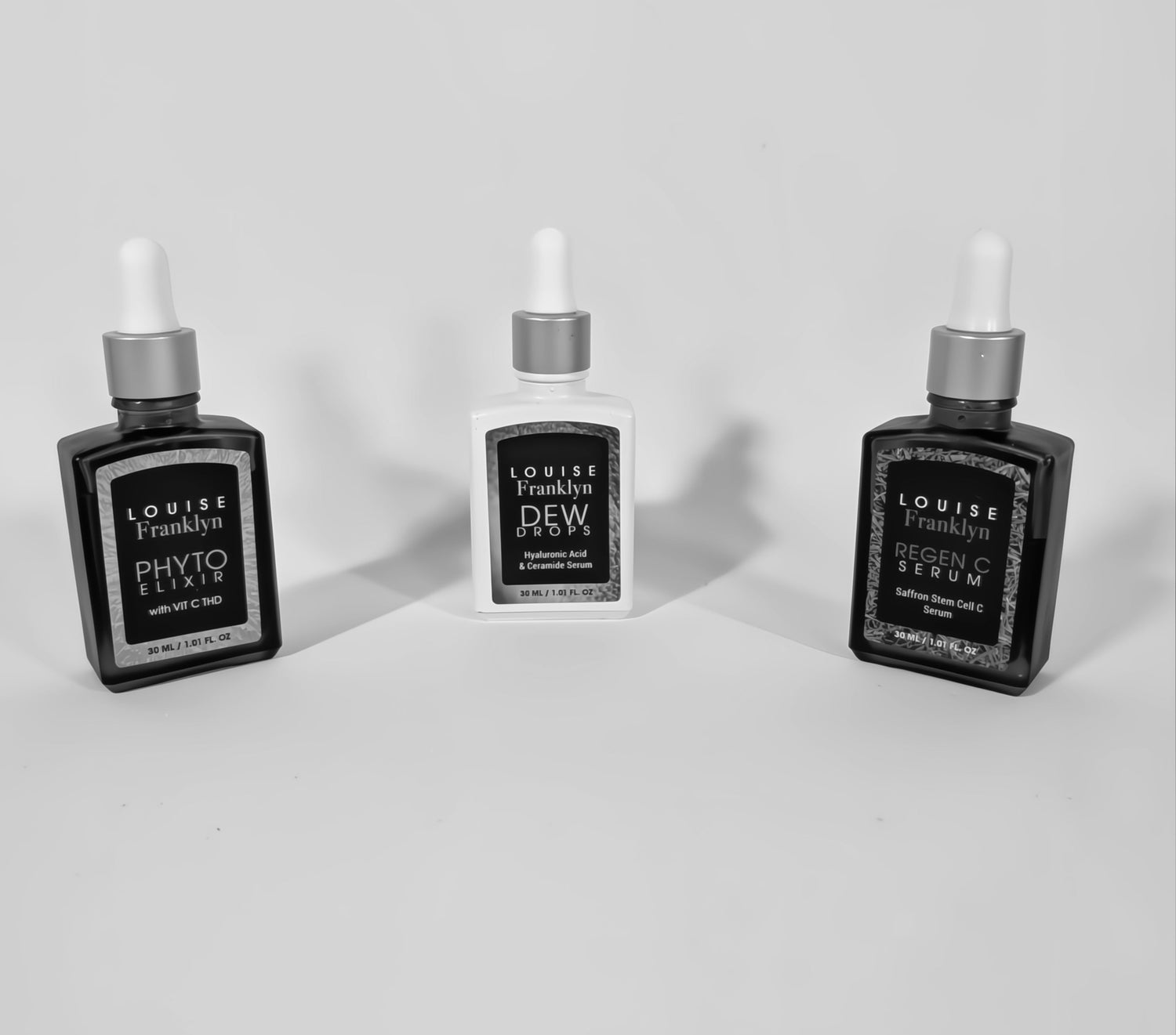 three premium skincare droppers in black and white. from Louise Franklyn.